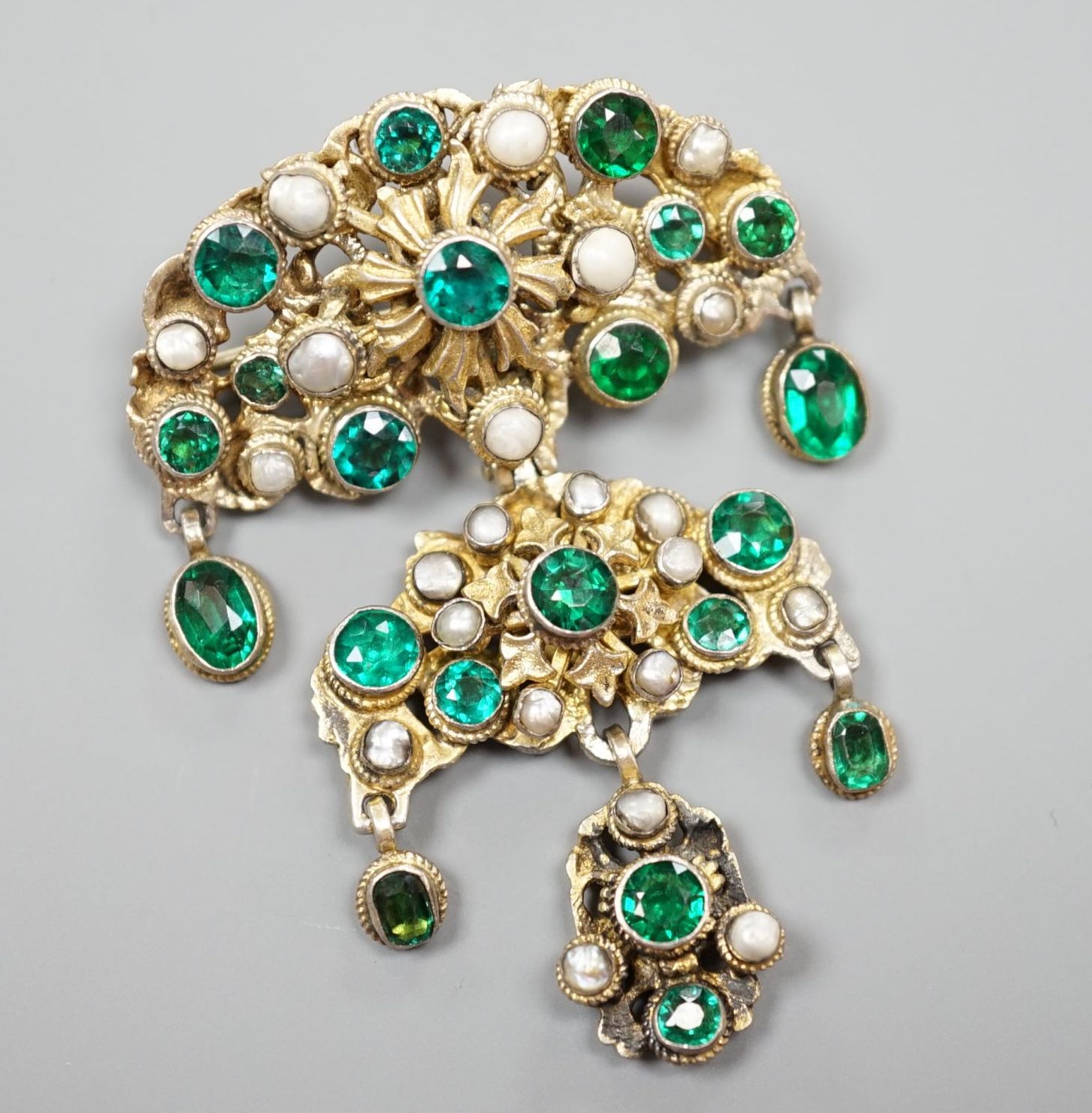 An Austro Hungarian gilt white metal, baroque pearl and green paste set drop pendant brooch, 59mm.